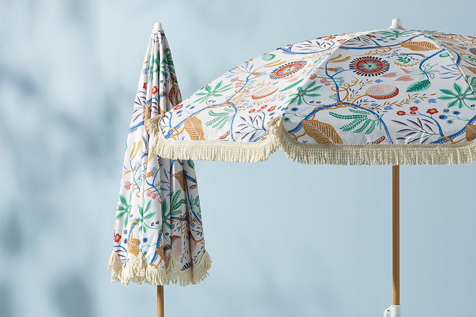 Scion x Habitat mr foxprinted orange beach towel on sand.