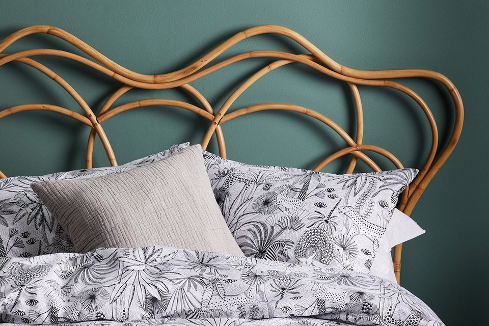 Patterned pillowcases on wooden bed.