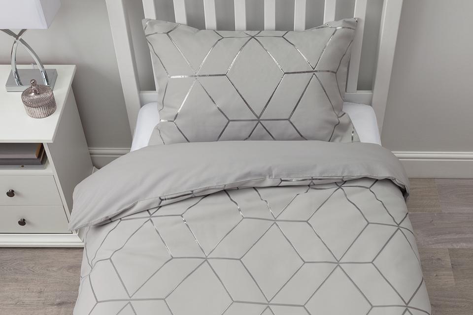 A white and silver jacquard geo print bedding set.