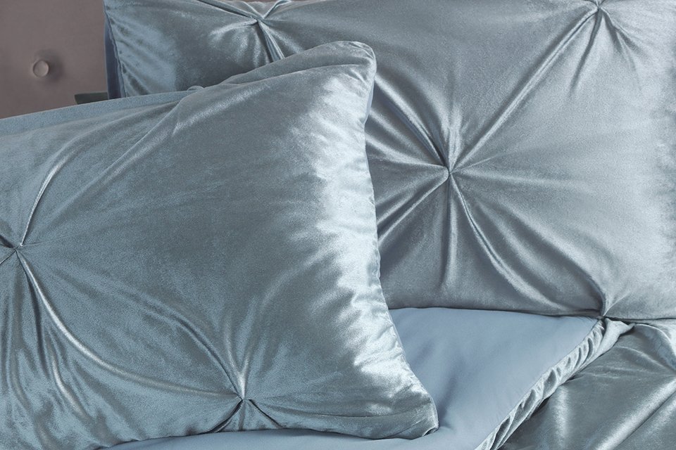 A teal velvet pintuck bedding set.