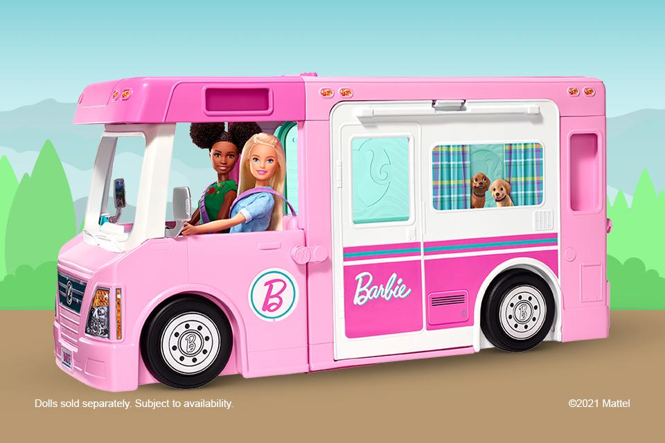Barbie peeping out of her Dreamcamper van with Ken and pet dolls.
