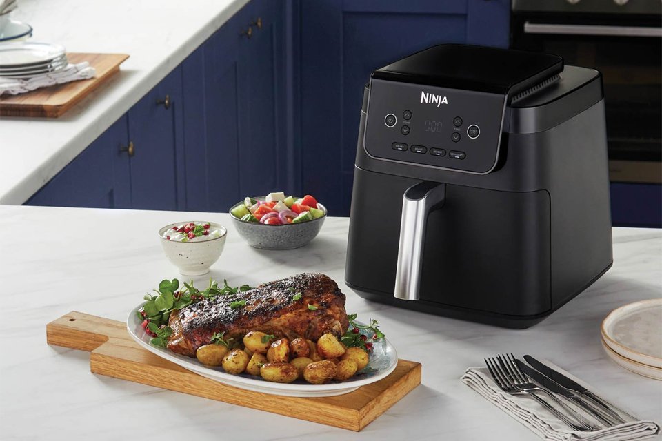 A Ninja AF170UK 6.2L Air Fryer in black colour placed on a kitchen counter. 