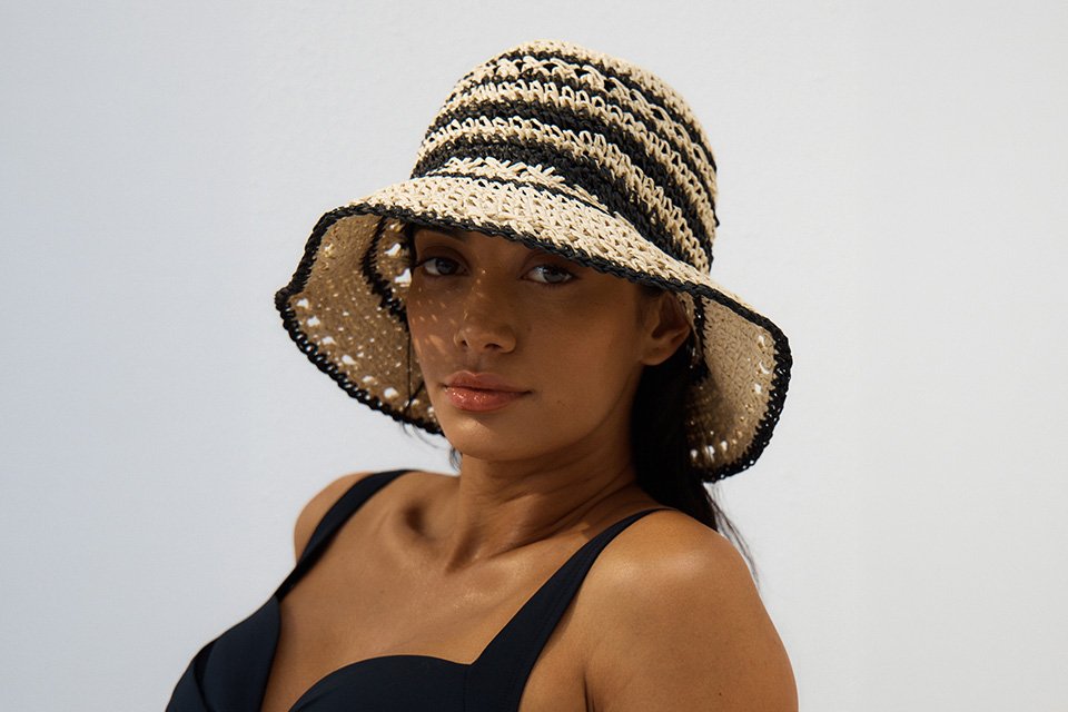 A woman wearing Mono Straw Cloche Hat.