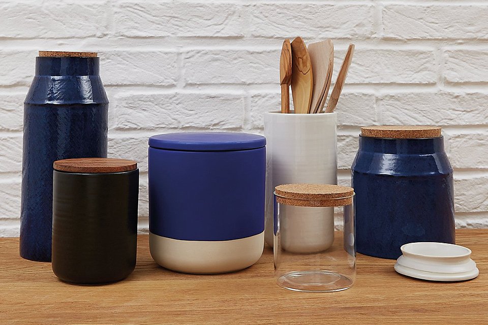 Blue and white kitchen containers and jars on kitchen sideboard.