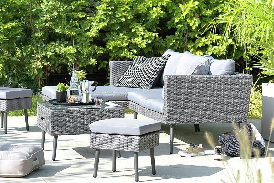 A grey 5 seater rattan effect corner sofa set placed on a patio.