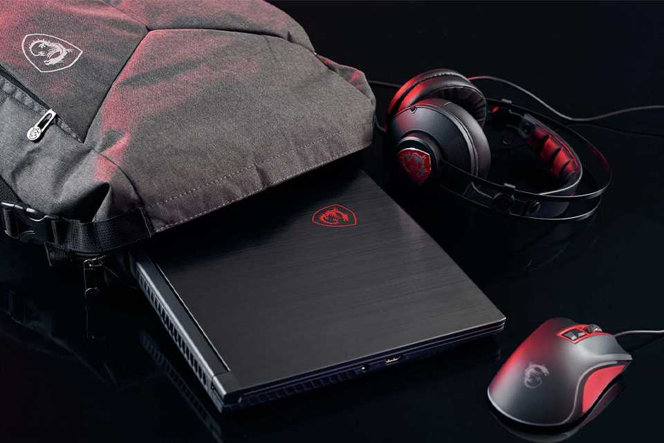 A gaming laptop, mouse and headset and a laptop bag.
