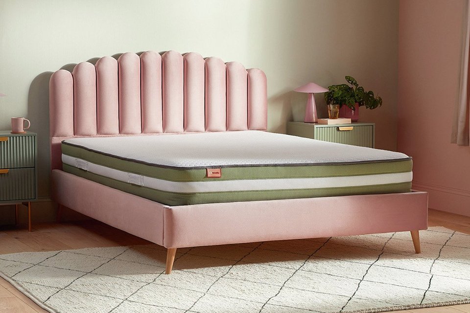 Pink headboard with mattress.