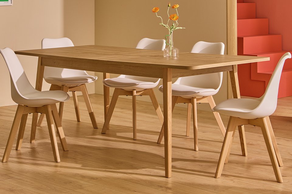A Habitat Sylas extending 6 seater dining table in wood-effect in a dining room.
