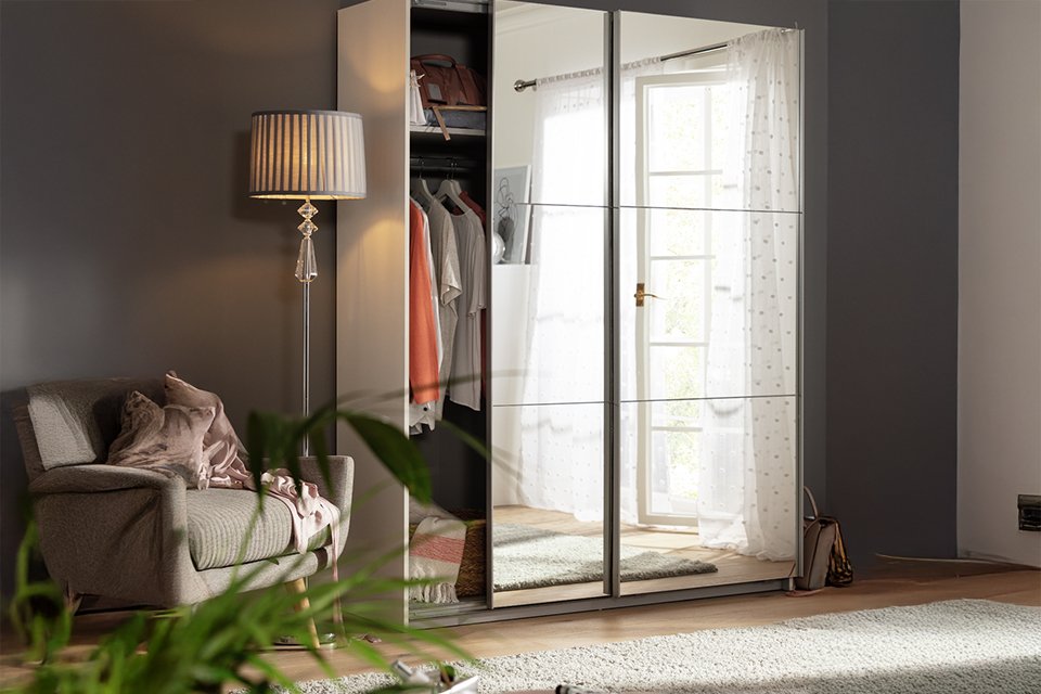 A Habitat Holsted Mirrored 150cm Sliding Wardrobe in a bedroom.