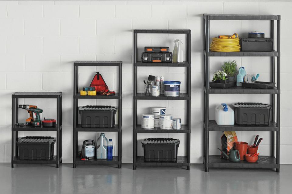 3 different sized shelving units being used for storage in a garage.