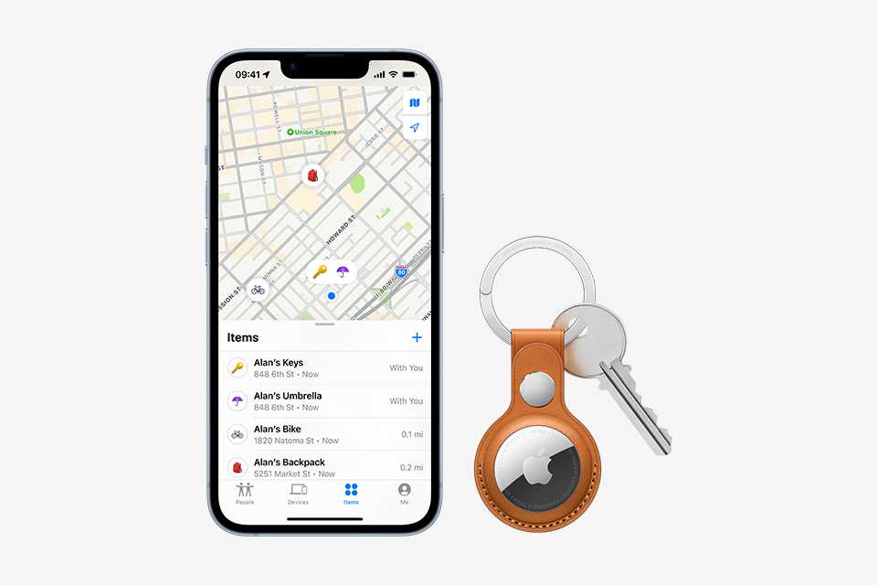 An Apple Airtag with key attached, pleaced next to an Apple iPhone that shows Apple Maps.