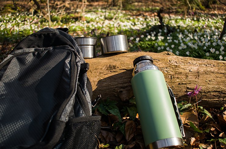 Green flask with backpack