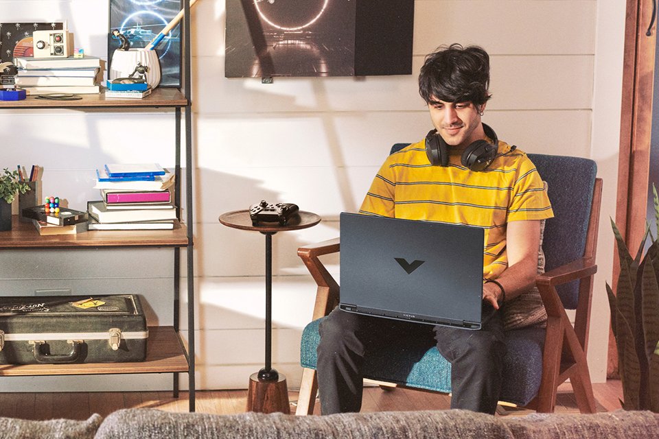 A man playing a game on HP Victus 15.6in i5 16GB 512GB RTX3050 Gaming Laptop Bundle.