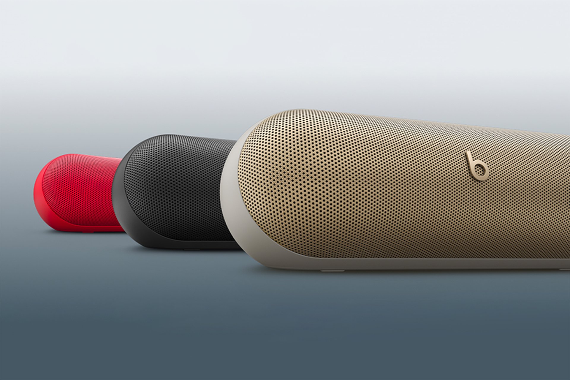 Three Beats Pill portable wireless Bluetooth speakers in black, red and beige. 