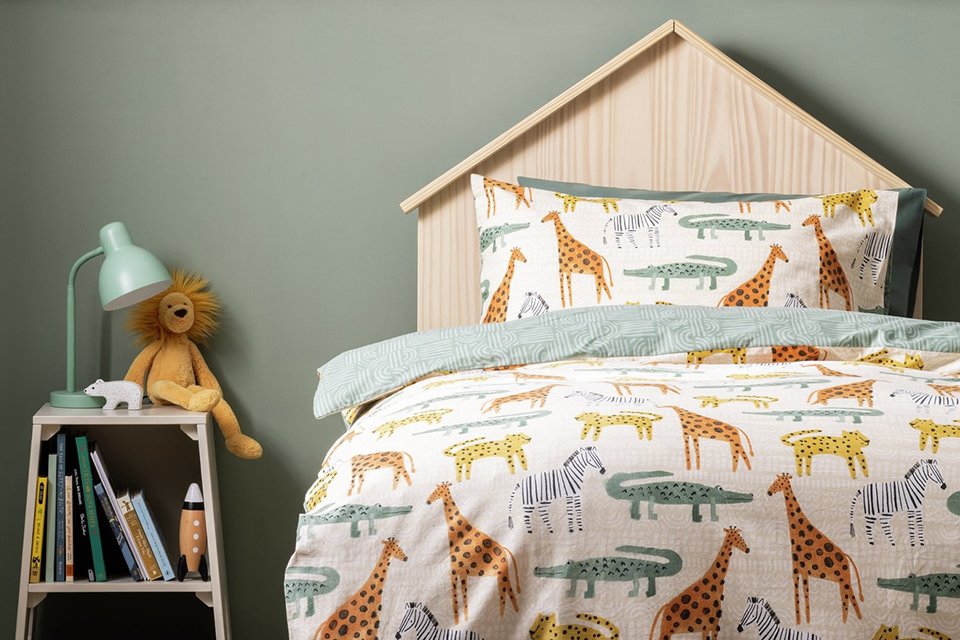 A multicoloured, floral print bedding in a kid's bedroom.