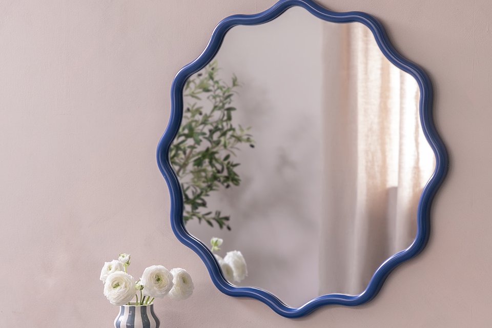: A Habitat blue wavy round wall mirror.