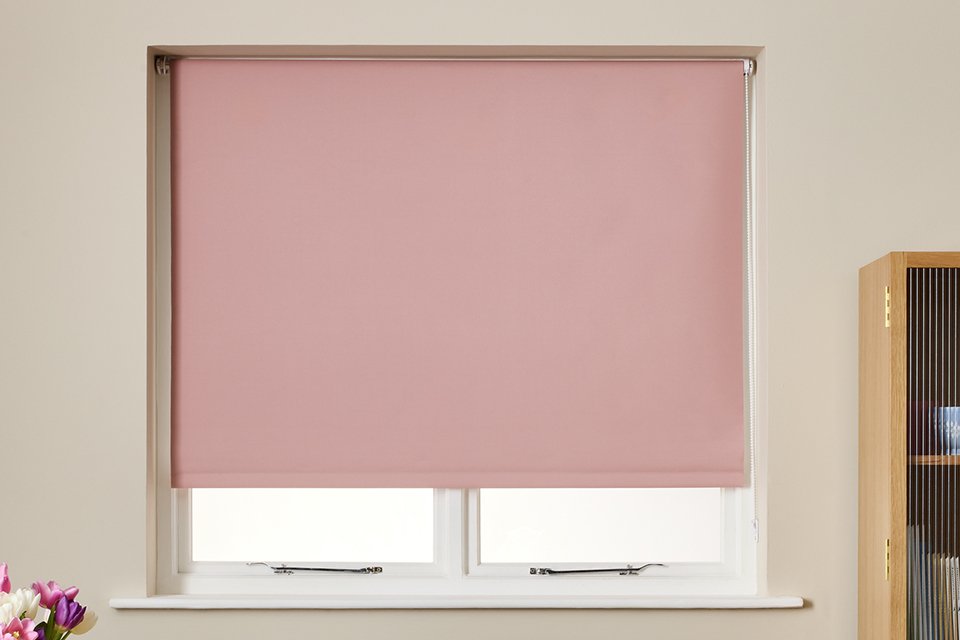A Habitat blackout blush roller blind.