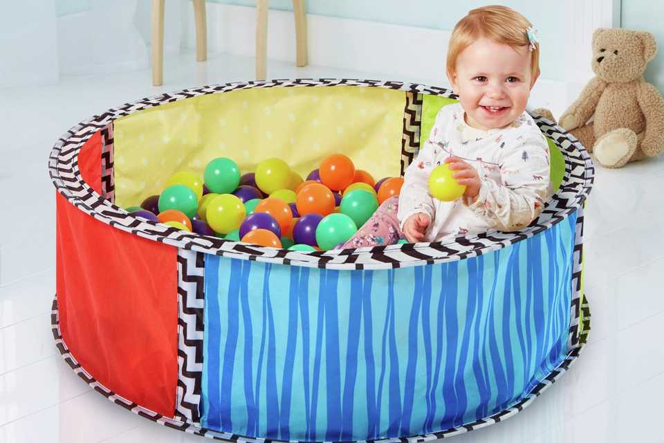 Child playing in ball pool.