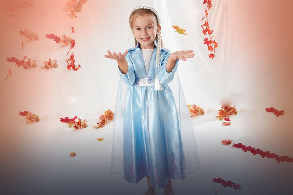 A young girl wears an Elsa fancy dress costume.