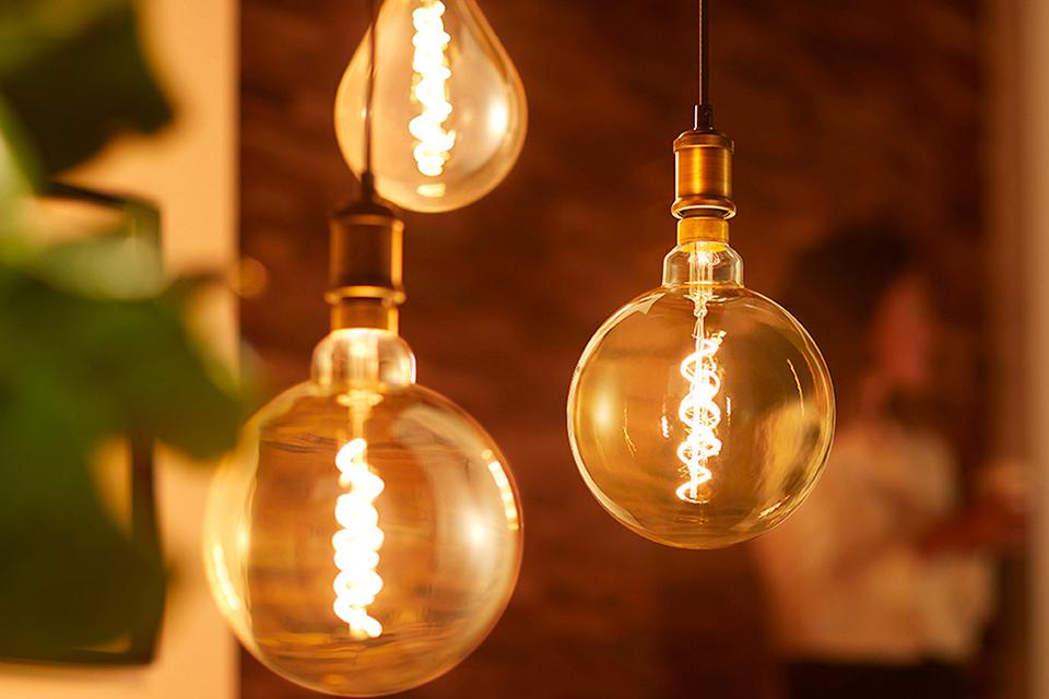 Close up image of three light bulbs hanging from the ceiling.