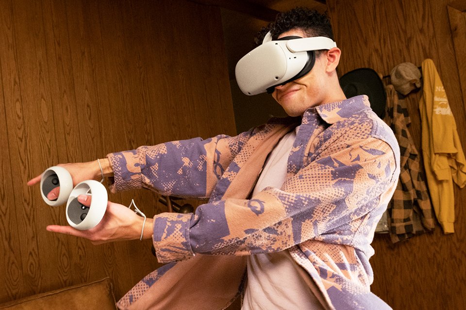 A person using Meta Quest 2 with controllers in hand.