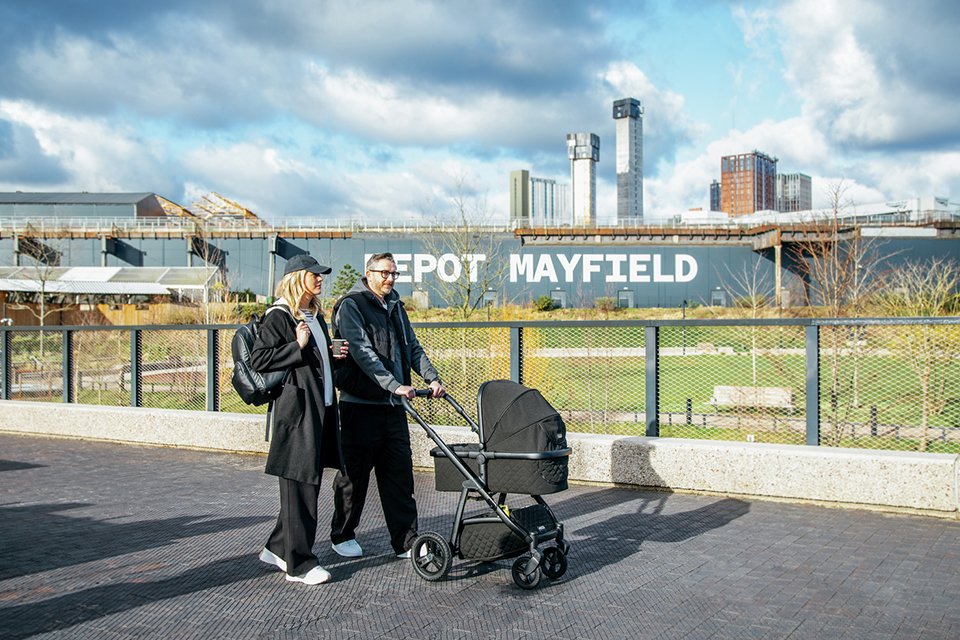 Parents walking while taking their baby out in a Cosatto Wow 3 Pram and Pushchair.
