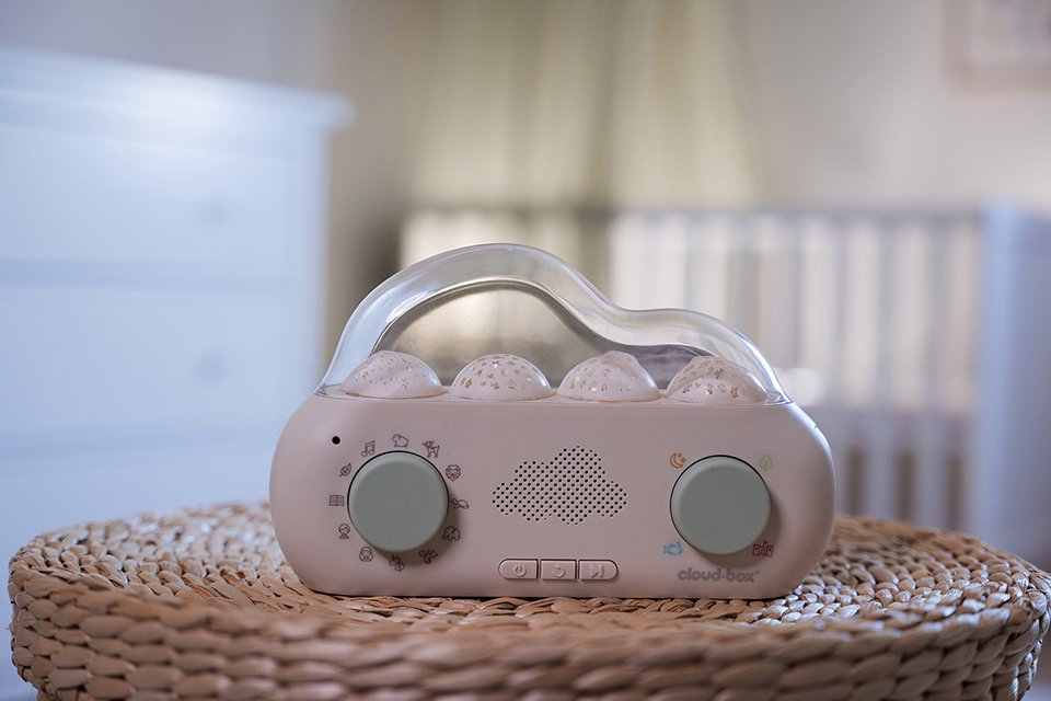 A Cloud B CloudBox story telling nightlight projector on a table.