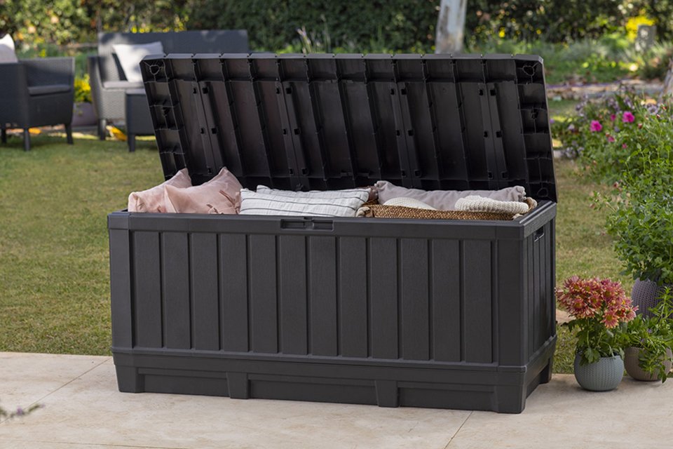 Keter Kentwood 350L outdoor garden storage box open with cushions placed inside.