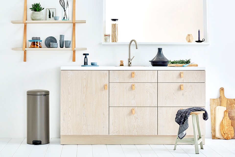 A Brabantia kitchen bin next to a kitchen worktop.