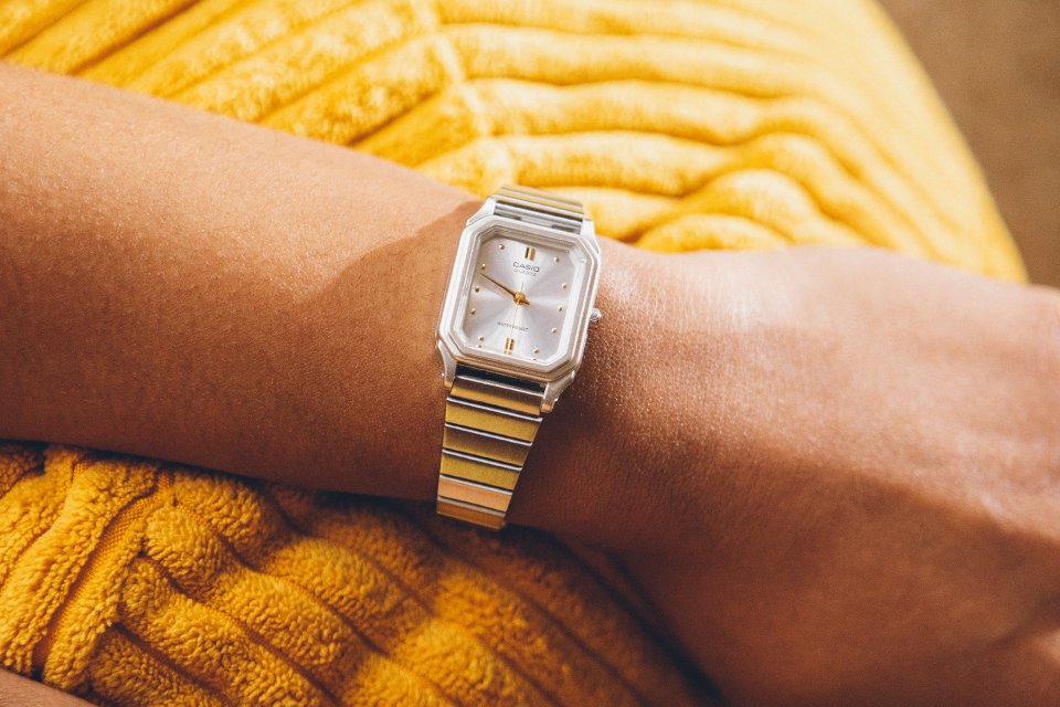 A golden Casio Vintage watch on a woman's wrist.