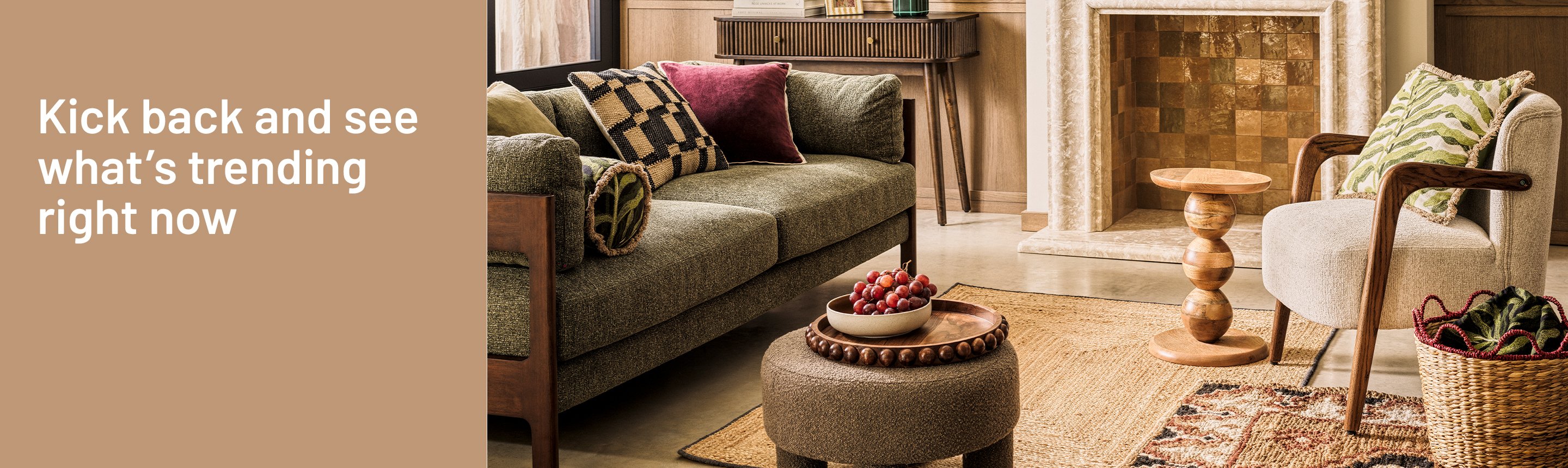 A banner displaying a verde luxe living room decorated with a rug, a sofa with patterned cushions, a coffee table, and a table lamp.