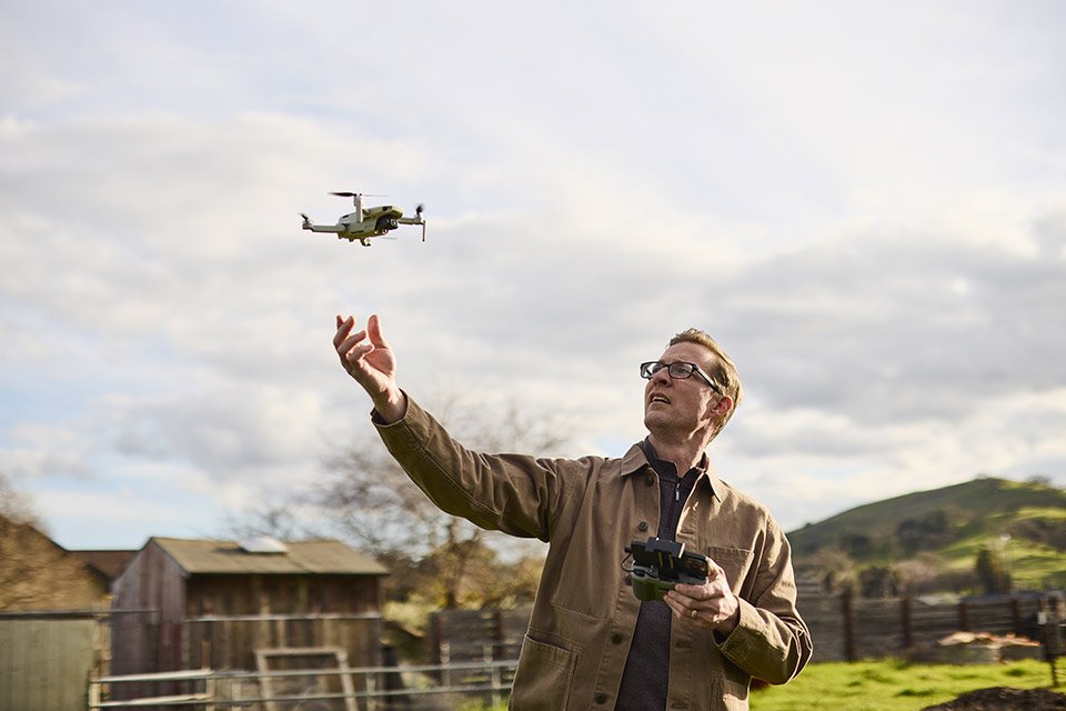 Photographer flying a drone in the neighbourhood.