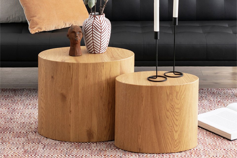 Furniture To Go Mice oval coffee tables placed near a black sofa in a living room.