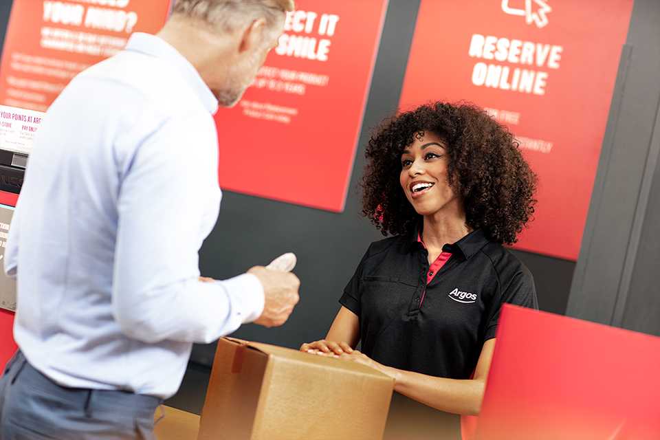 A man talking to an female Argos employee.
