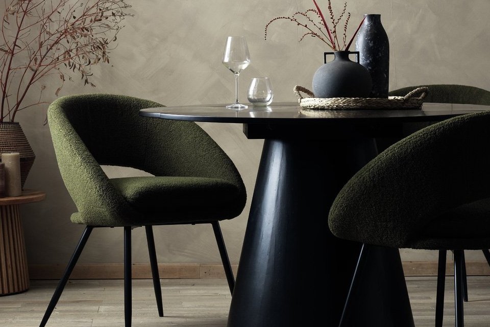 A solid wood 4-seater dining table in black.