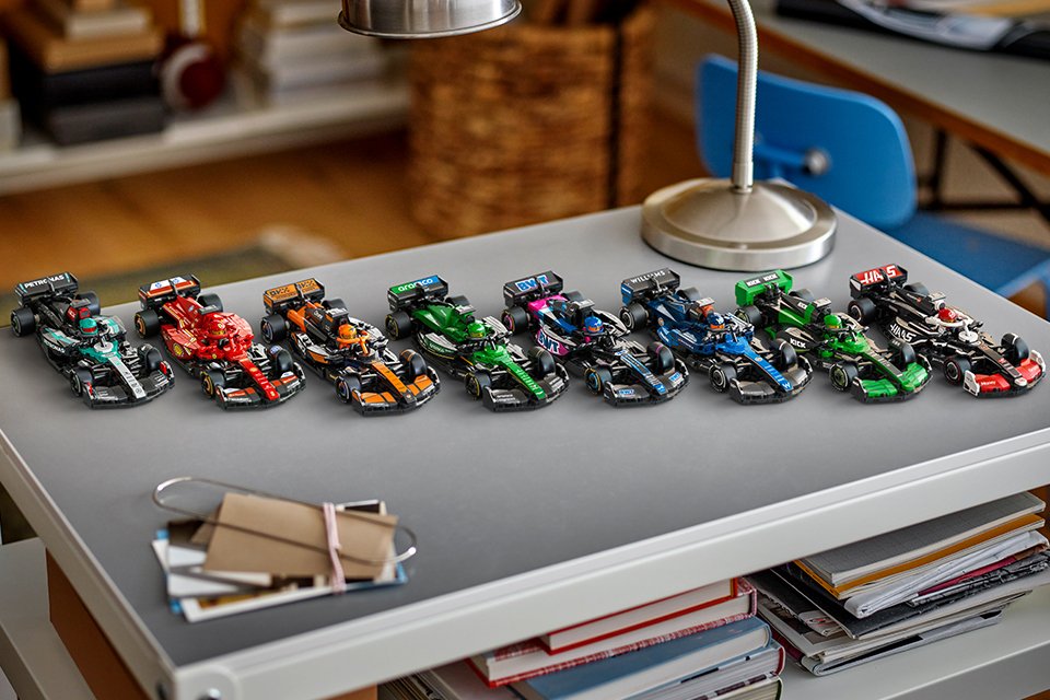 Eight of the new 2025 season Speed Champions Formula 1® team cars lined up on a desk.