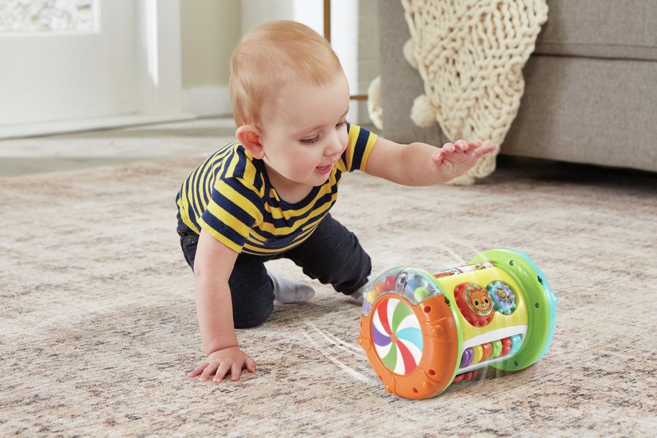 A child playing with a Vtech Explore And Discover roller.