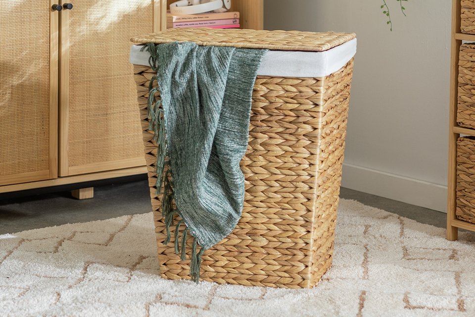 A Habitat natural rectangle Water Hyacinth laundry basket in a utility room.
