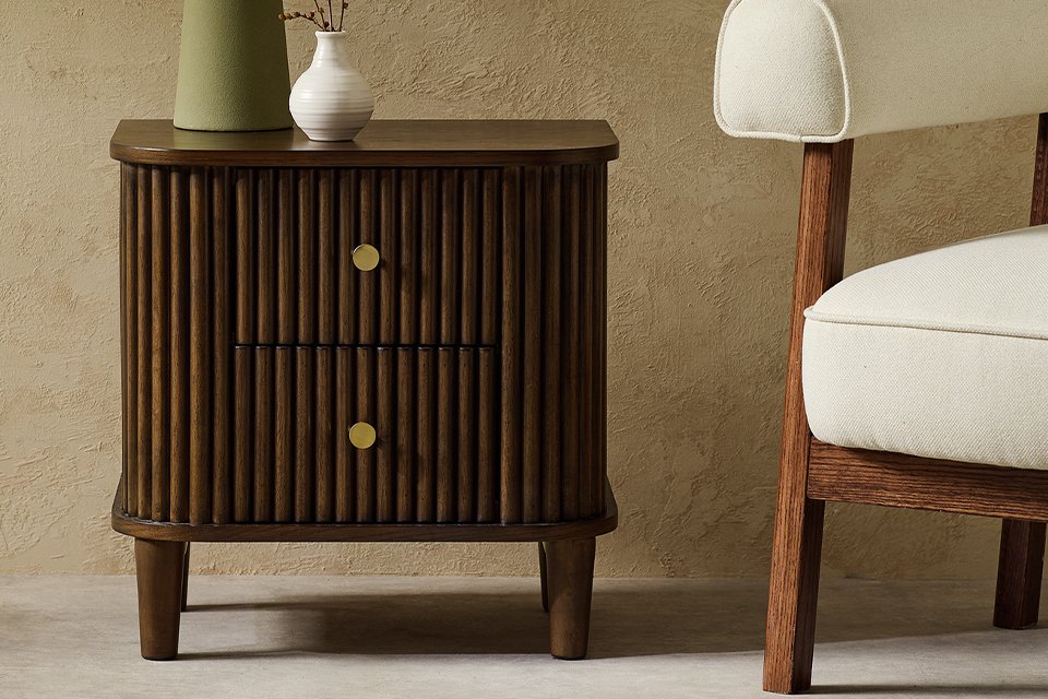 A Habitat Kendi Side Table in a living room next to a white chair.