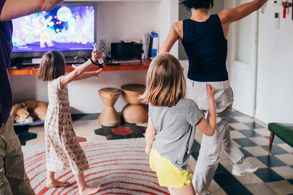 Family playing with games console indoors.