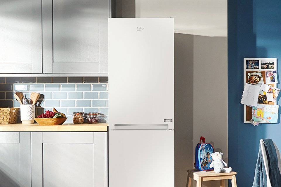 A white Beko fridge freezer in a kitchen enviornment.
