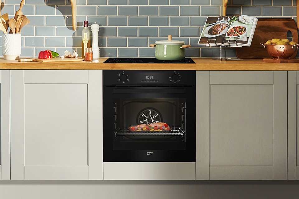 A Beko single oven with food baking inside it.
