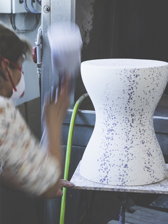 A woman working on Habitat Jackson side table in a factory. 