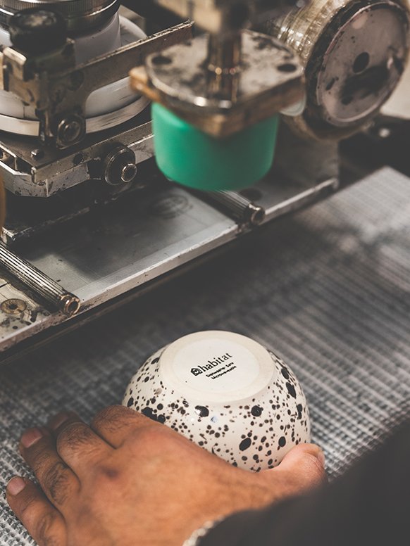 A person working on a bowl from Habitat Jackson dinnerware set.