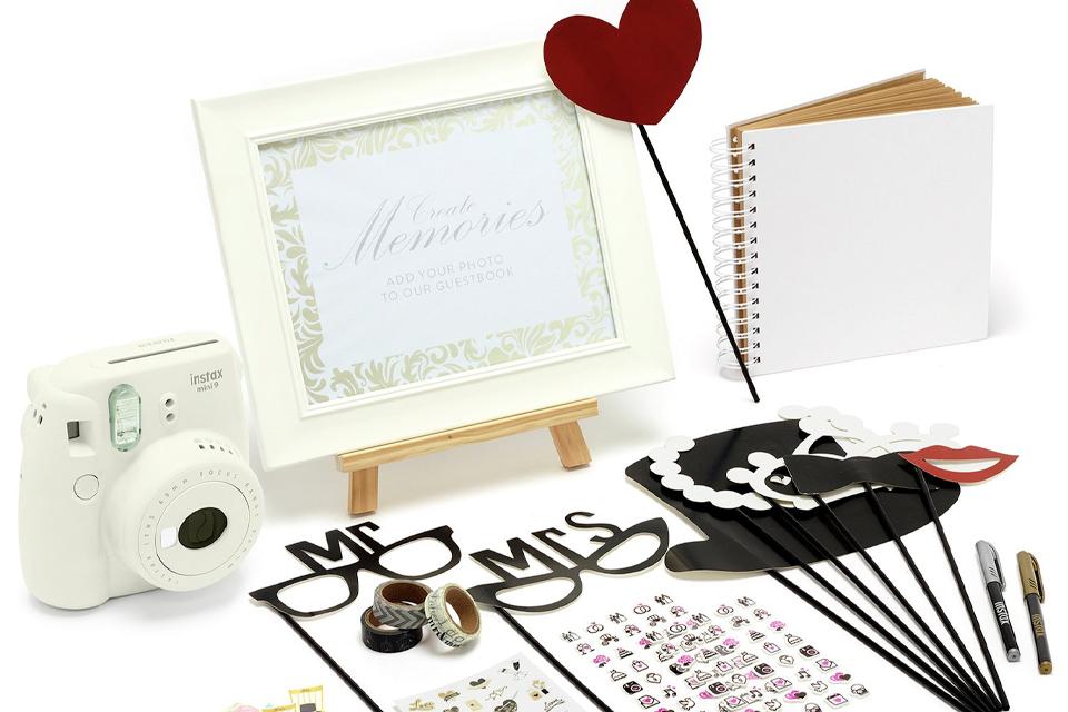 Photobooth accessories including camera, frame and pens.