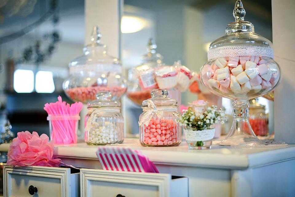 Different types of pink sweets including candies on a table.