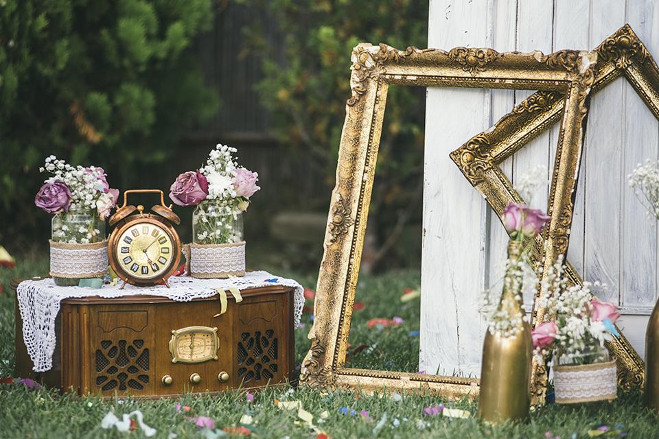 Vintage decorative items including clock and photo frames in a garden.