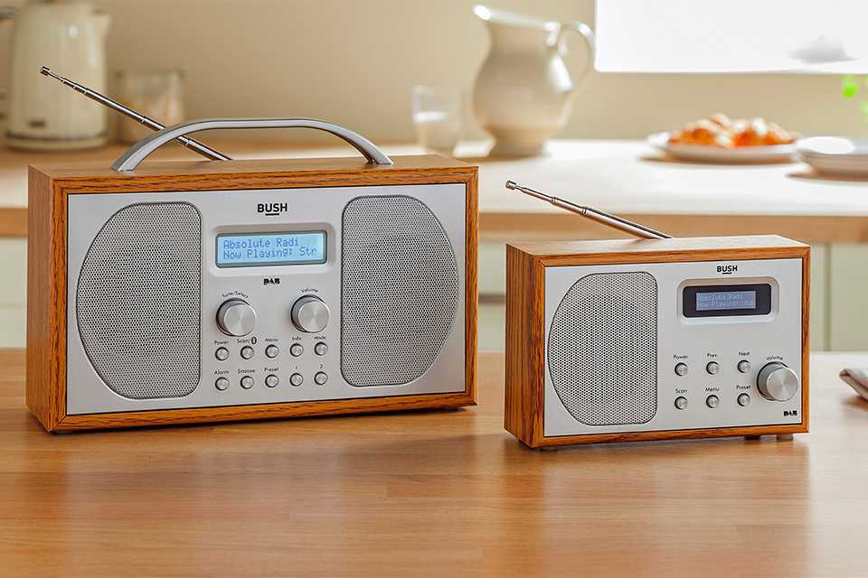 Bush DAB bluetooth wooden radios on a table.