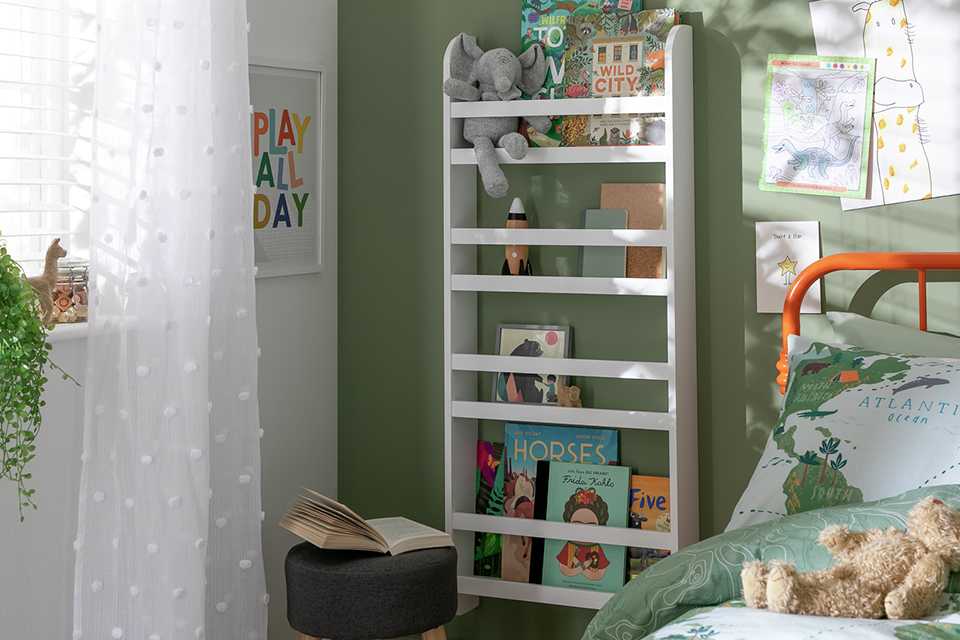 Slimeline shelf with books and teddies in kids bedroom for a cosy reading corner.