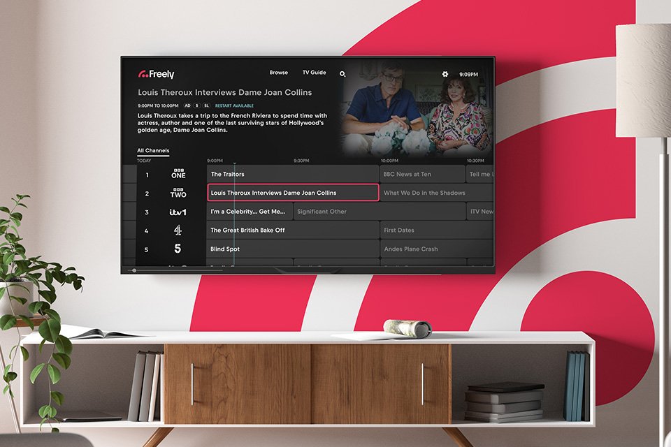 Freely's TV guide interface on a smart television in a living room setup.